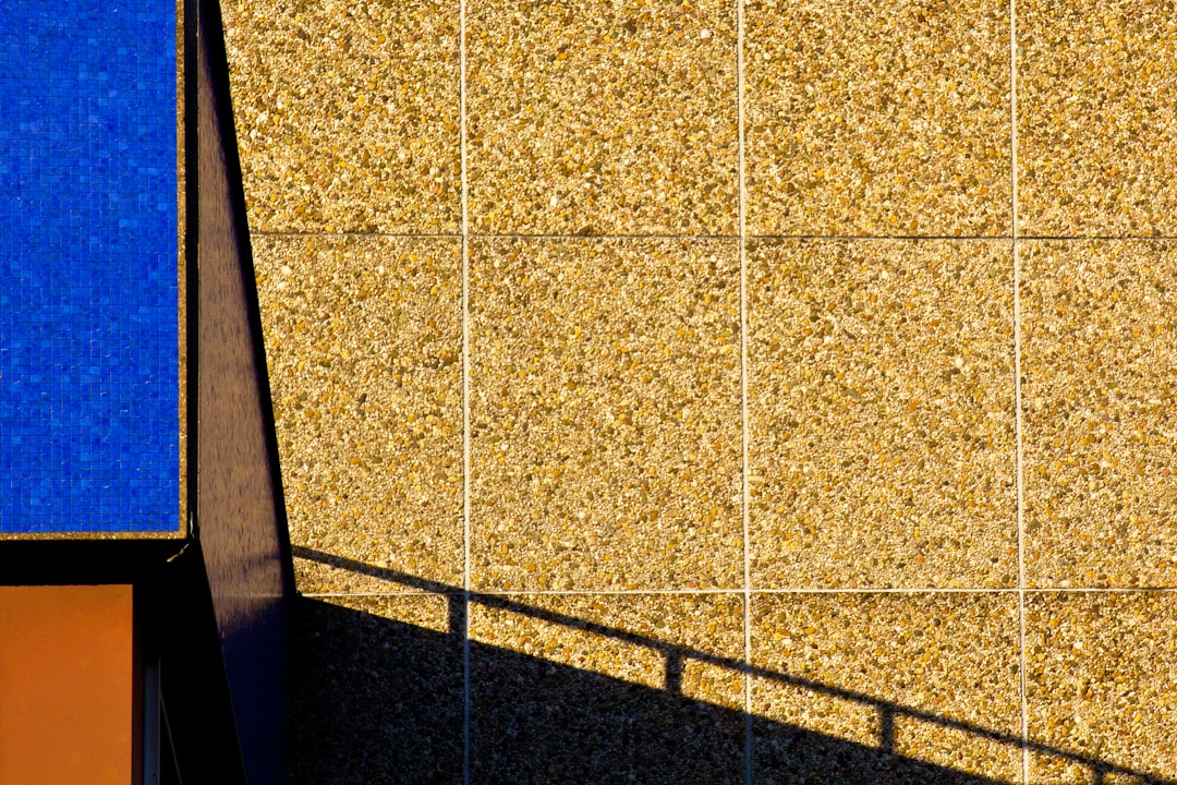 A building with a blue and orange wall next to it