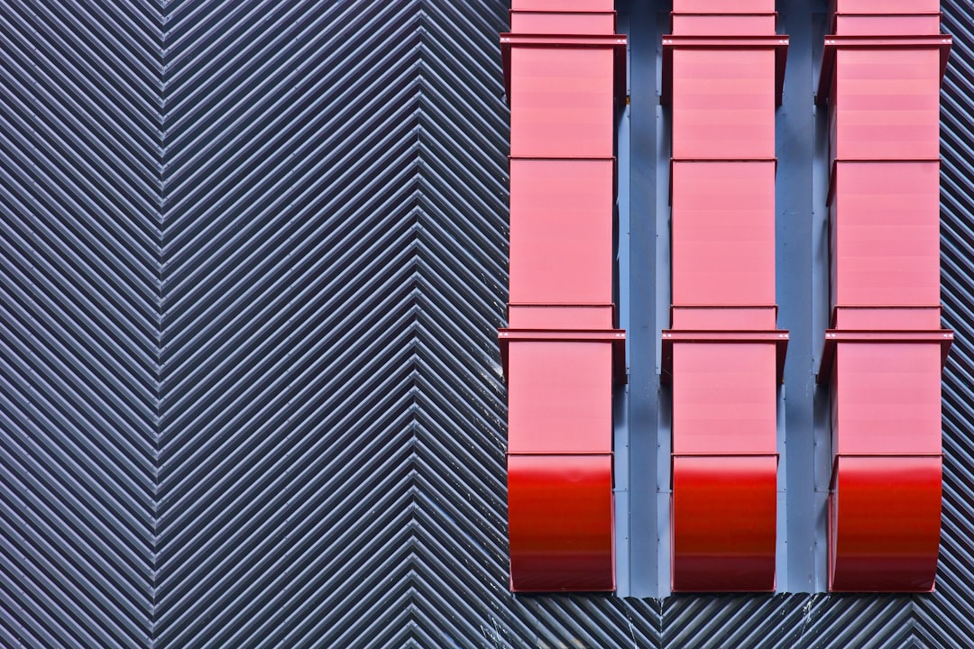 A tall building with a red window on it's side