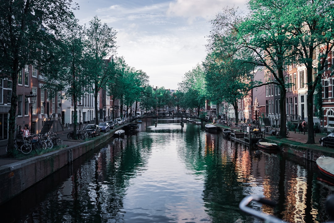 A canal in amsterdam, lined with buildings.
