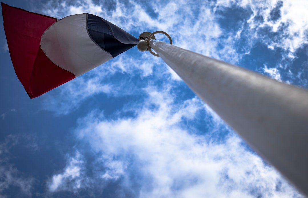 A red, white and black flag on a pole