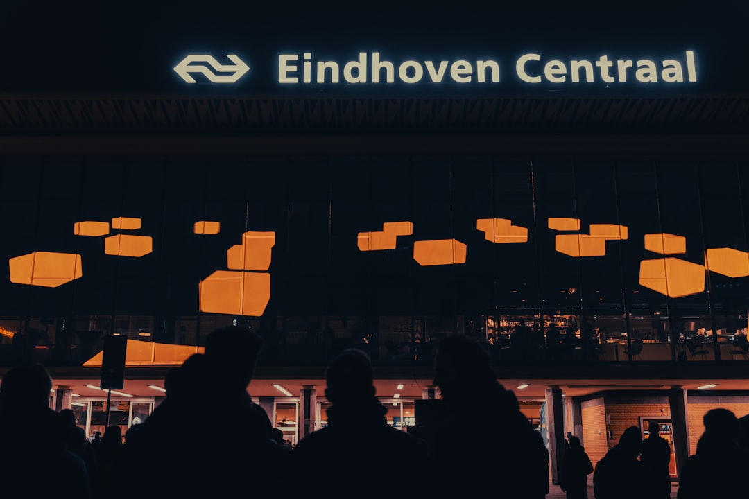 a group of people in front of a building with many windows