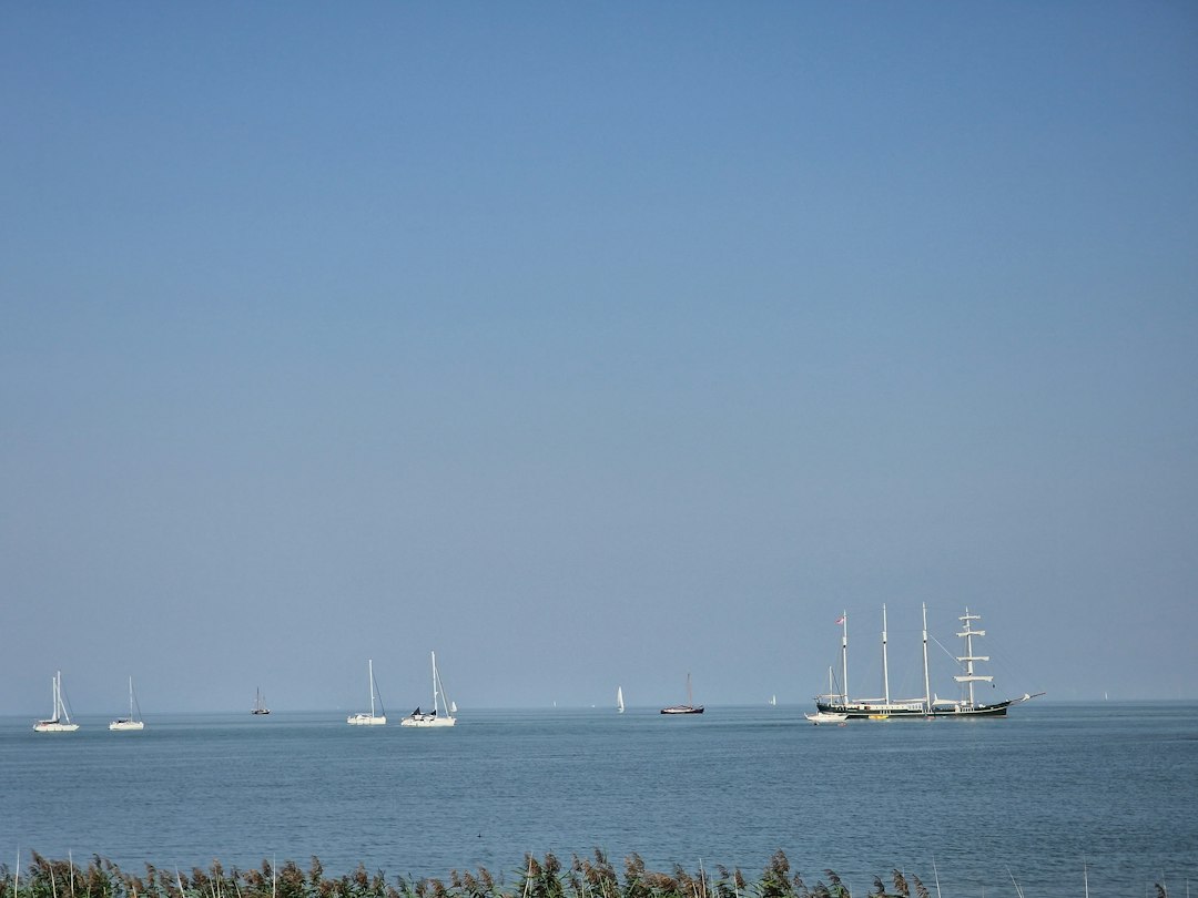 a group of boats floating on top of a large body of water
