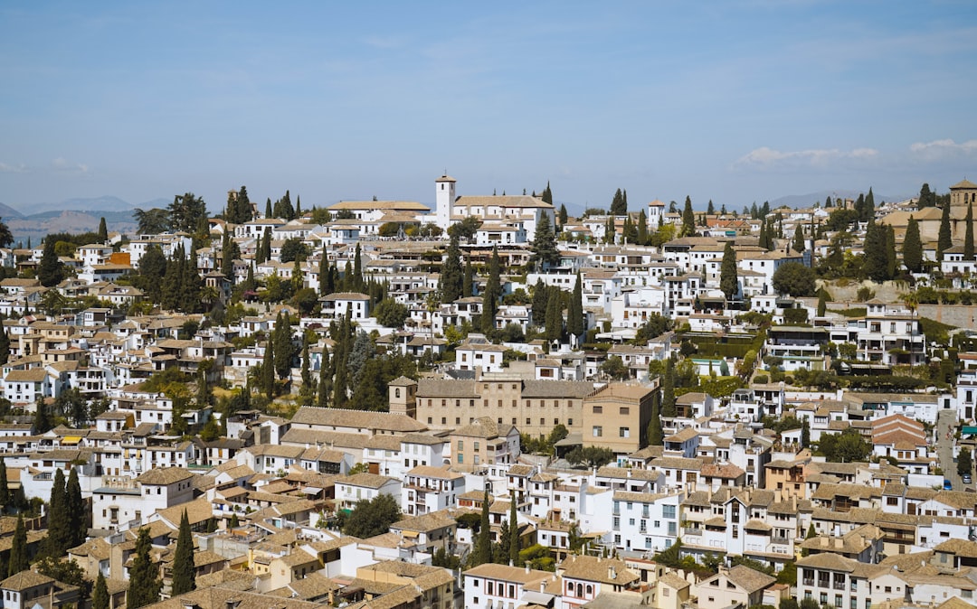 a city with lots of white buildings and trees