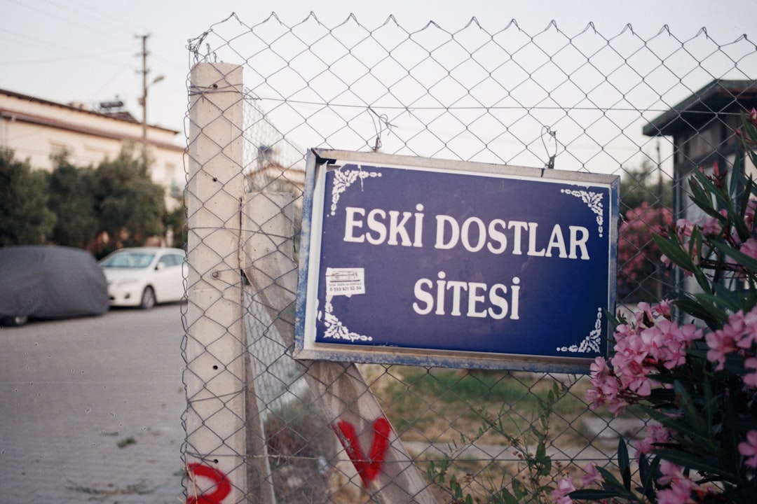a sign on a fence that says eski dostar sitesi