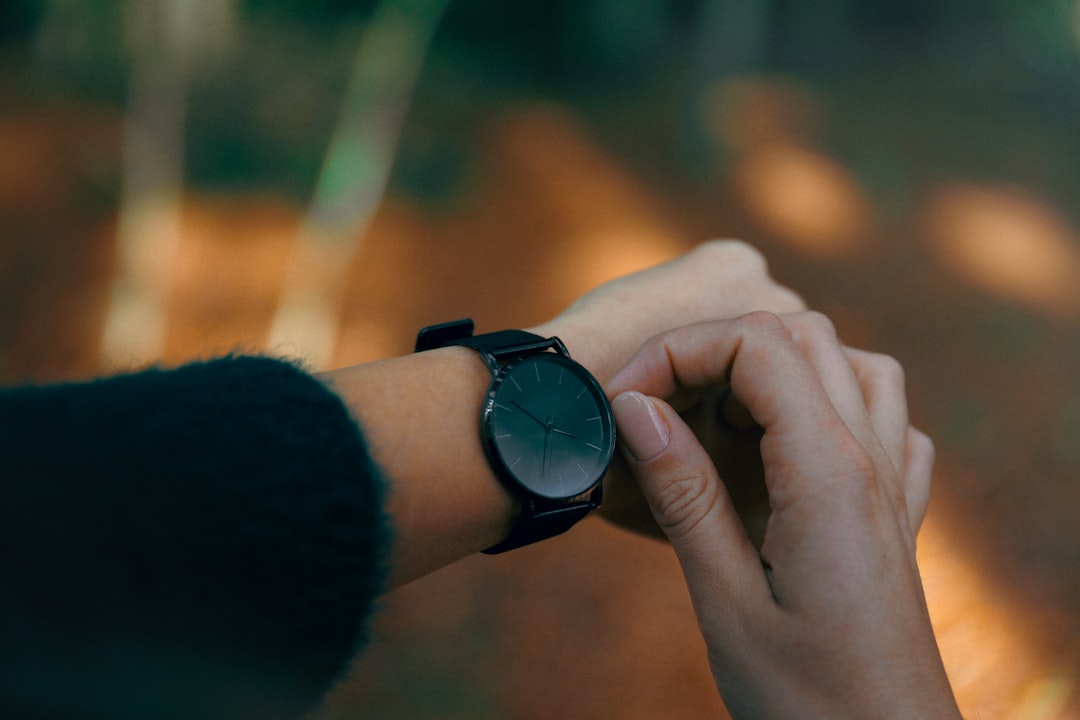 person wearing black analog watch